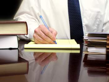 Lawyer writing at desk